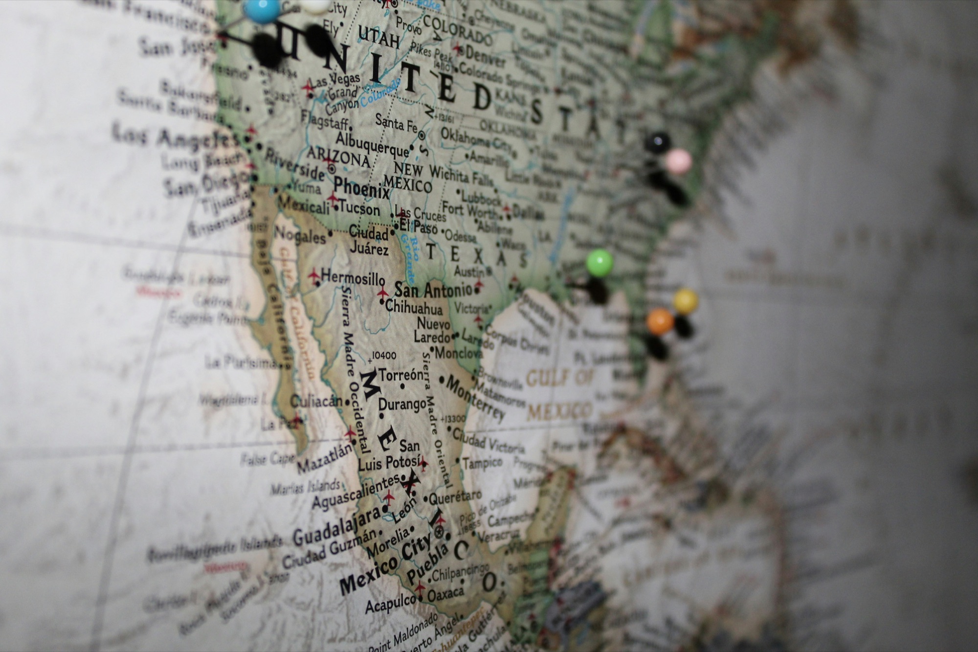 A map of North America marked with colorful travel pins.